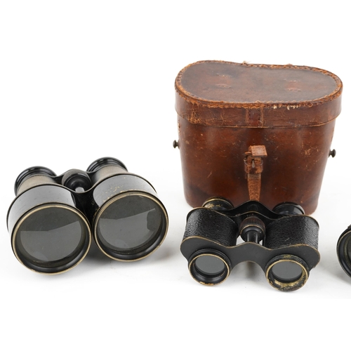  Three pairs of vintage binoculars, one with tan leather case, including J E Steward.