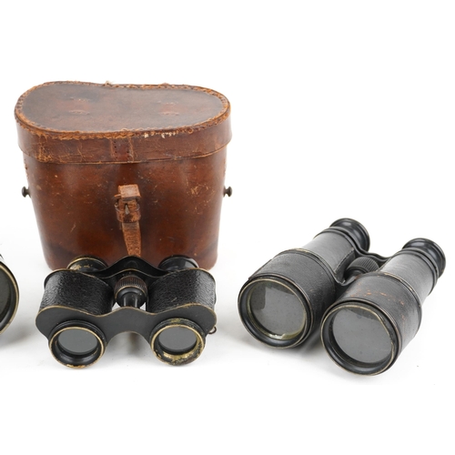  Three pairs of vintage binoculars, one with tan leather case, including J E Steward.