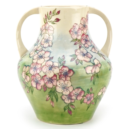 A large Moorcroft Spring Blossom patterned twin handled vase by Jennifer James, 26cm high.