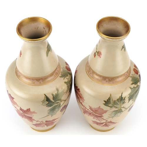 56 - A pair of Doulton Lambeth Carrara vases hand painted with autumn leaves and berries, 32cm high.