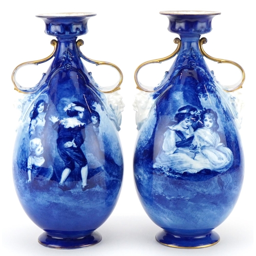 A pair of Royal Doulton Blue Children series ware vases with twin grotesque mask handles, 29.5cm high.