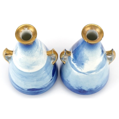 53 - A pair of Royal Doulton Blue Children series ware conical vases with twin handles, 17cm high.