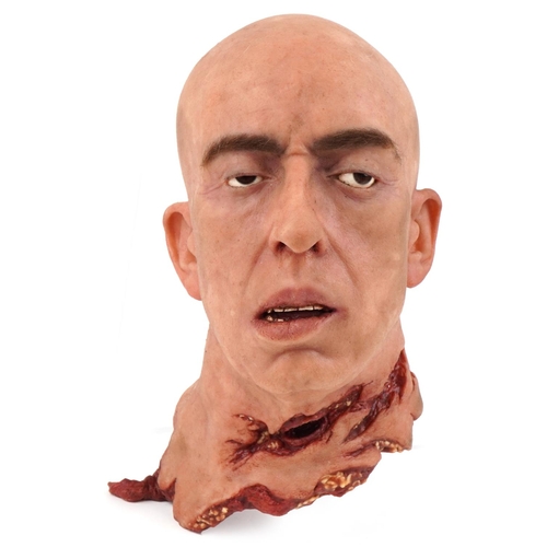  A life-like latex decapitated head, 30cm high.