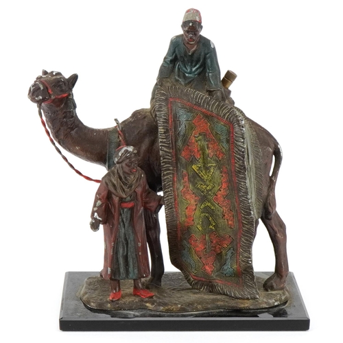 10 - A cold painted spelter table lighter in the form of an Arab carpet seller on a camel, 19cm high.