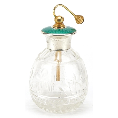 628 - An Art Deco glass atomiser with sterling silver and green guilloche enamel lid, 13cm high.