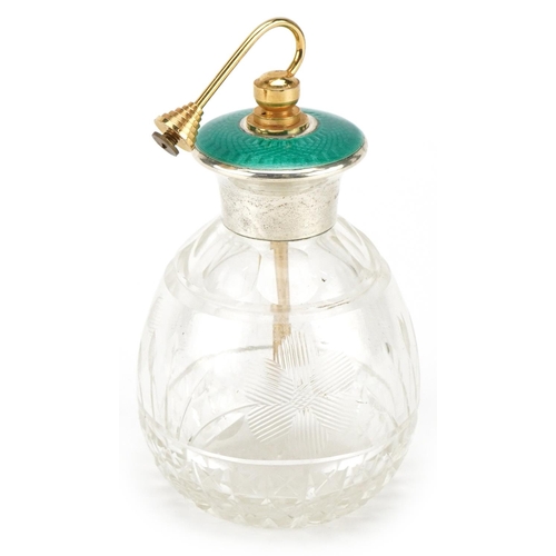 628 - An Art Deco glass atomiser with sterling silver and green guilloche enamel lid, 13cm high.