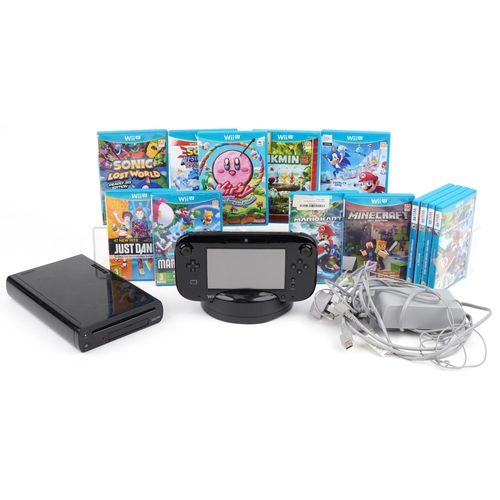 1128 - A Nintendo Wii U games console with accessories and a collection of games including Mario & Sonic at... 