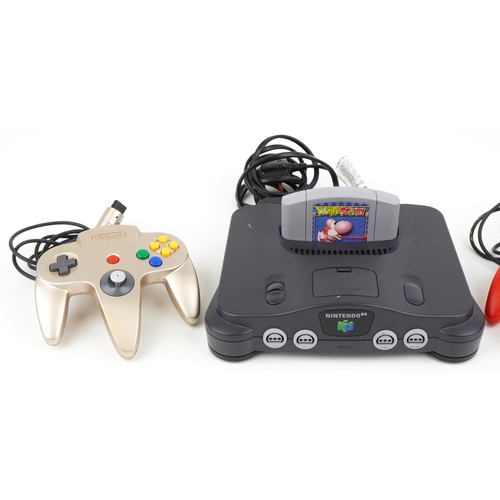 1127 - A Nintendo 64 games console with controllers and Yoshi's Story game.