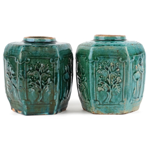 2599 - A pair of Chinese hexagonal green glazed terracotta vases, 20th century, each moulded in relief with... 