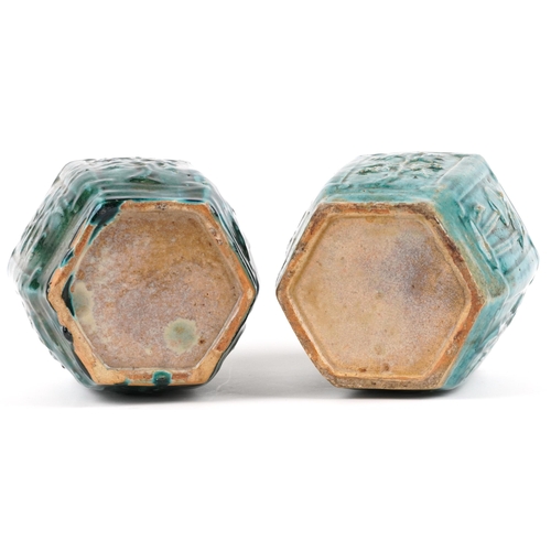 2599 - A pair of Chinese hexagonal green glazed terracotta vases, 20th century, each moulded in relief with... 