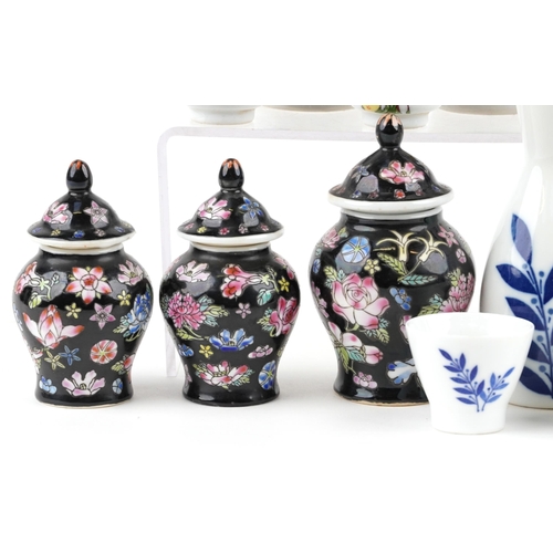 1642 - A small group of mixed Chinese porcelain items, 20th century, including a pair of sake decanters and... 