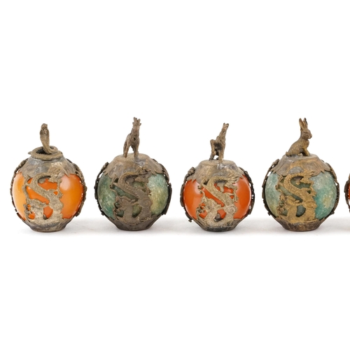 376 - A group of nine Tibetan gilt metal mounted jadeite and reconstituted amber zodiac balls, 20th centur... 