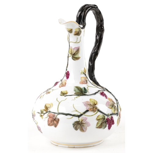 135 - An early 20th century continental porcelain pitcher with hand painted floral decoration, 31cm high.