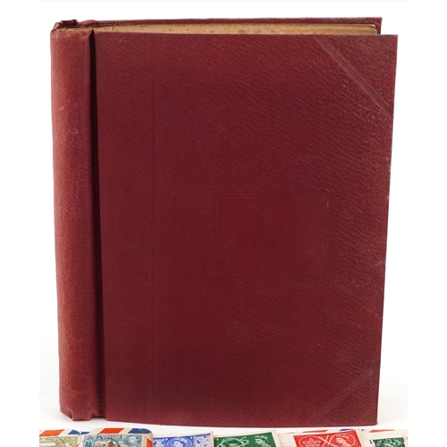 1329 - A red stamp album containing 19th century and later British and world stamps including China, France... 