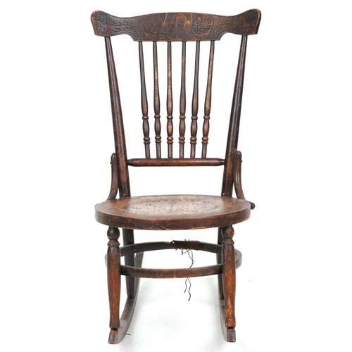 2187 - An early 20th century American carved beech rocking chair, 81cm high x 47cm wide.