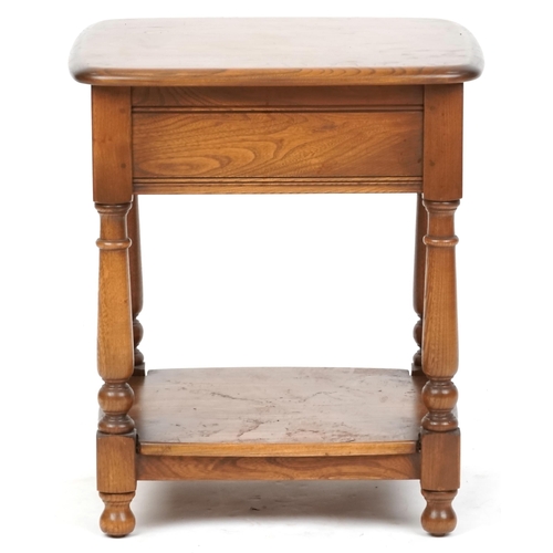 2111 - An Ercol stained beech two tier side table on turned supports, 54cm H x 48cm W x 44cm D.