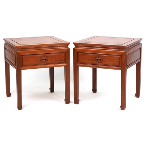 2110 - A pair of Chinese hardwood lamp tables, late 20th century, each fitted with a drawer and raised on b... 