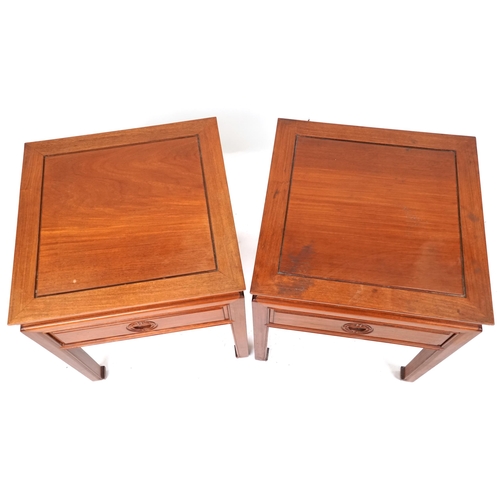 2110 - A pair of Chinese hardwood lamp tables, late 20th century, each fitted with a drawer and raised on b... 