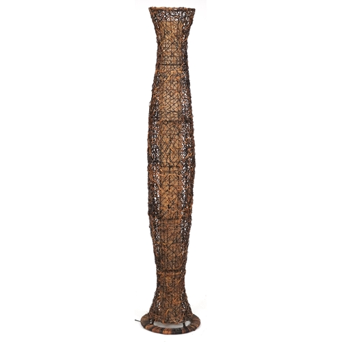 2120 - A contemporary rattan floor standing lamp of shaped cylindrical form on a circular base, 186cm high.