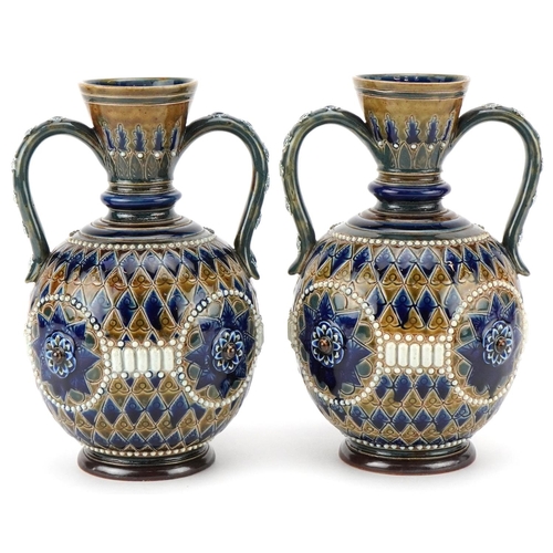 210 - A pair of late 19th century Doulton Lambeth stoneware two handled vases with stylized hand painted d... 