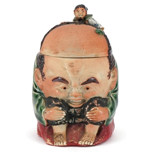 372 - A Japanese Sumida-Gawa porcelain tobacco jar and cover, Meiji period, modelled as a crouching man wi... 