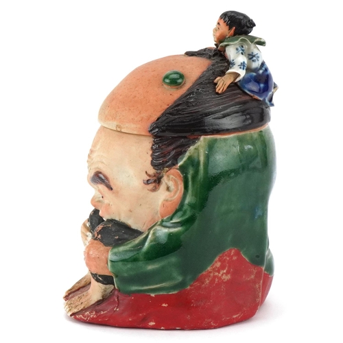 372 - A Japanese Sumida-Gawa porcelain tobacco jar and cover, Meiji period, modelled as a crouching man wi... 