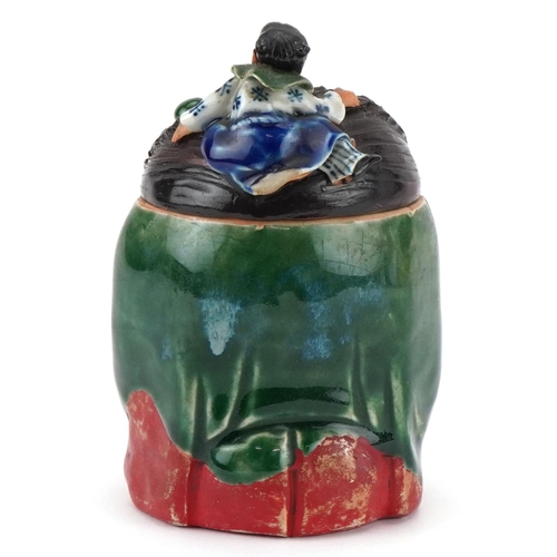 372 - A Japanese Sumida-Gawa porcelain tobacco jar and cover, Meiji period, modelled as a crouching man wi... 