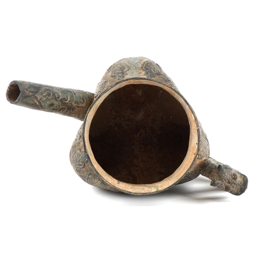 1601 - A Chinese archaistic bronze water pourer, 19th/20th century, with incised decoration and dragon hand... 