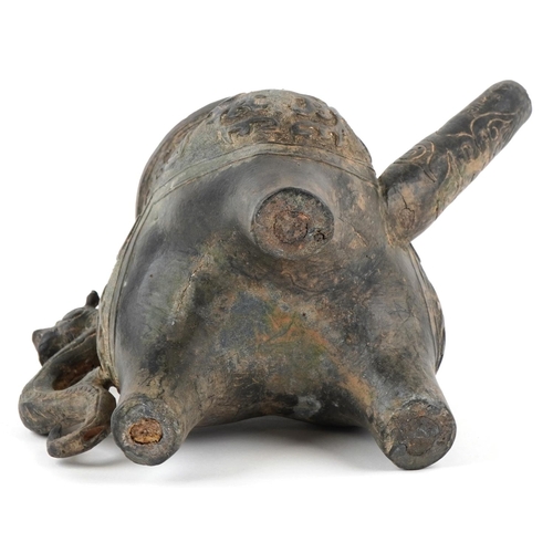 1601 - A Chinese archaistic bronze water pourer, 19th/20th century, with incised decoration and dragon hand... 