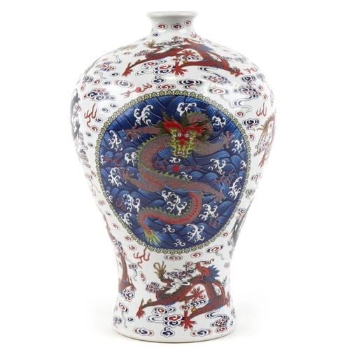 110 - A 20th century Chinese porcelain baluster vase hand painted with dragons in blues, greens and reds, ... 