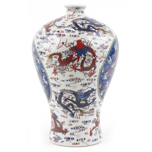 110 - A 20th century Chinese porcelain baluster vase hand painted with dragons in blues, greens and reds, ... 