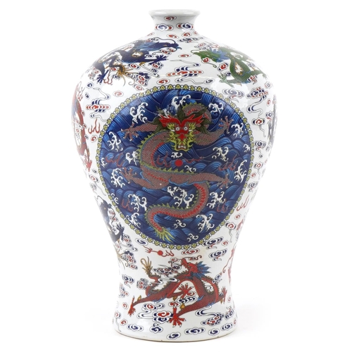 110 - A 20th century Chinese porcelain baluster vase hand painted with dragons in blues, greens and reds, ... 