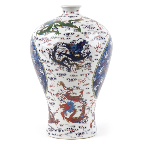 110 - A 20th century Chinese porcelain baluster vase hand painted with dragons in blues, greens and reds, ... 