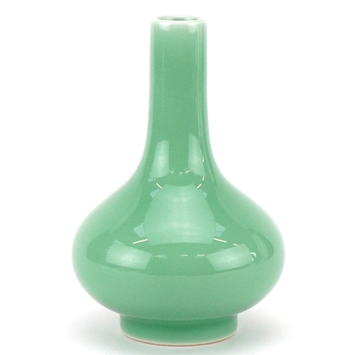 311 - A Chinese porcelain celadon glazed bottle neck vase, character marks to the base, 13cm high.