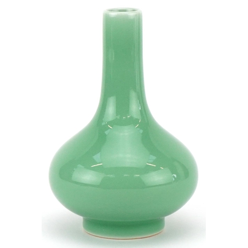 311 - A Chinese porcelain celadon glazed bottle neck vase, character marks to the base, 13cm high.