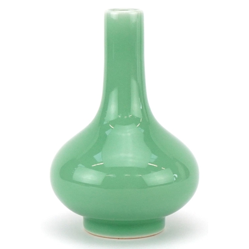 311 - A Chinese porcelain celadon glazed bottle neck vase, character marks to the base, 13cm high.