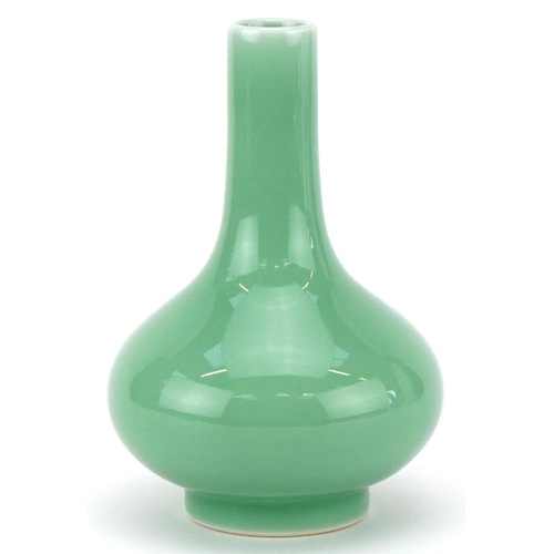 311 - A Chinese porcelain celadon glazed bottle neck vase, character marks to the base, 13cm high.