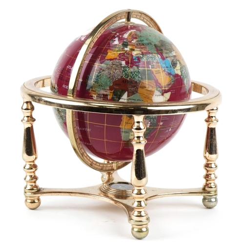 A contemporary polished stone table globe with brass stand and compass under tier, 30cm high.