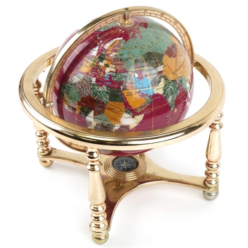 1597 - A contemporary polished stone table globe with brass stand and compass under tier, 30cm high.