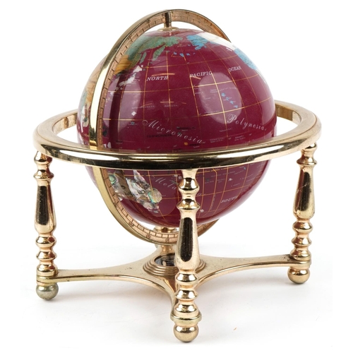 1597 - A contemporary polished stone table globe with brass stand and compass under tier, 30cm high.