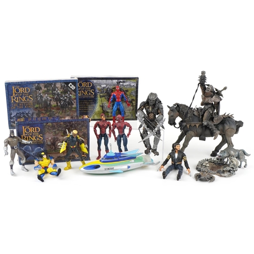 1099 - A group of action figures together with three The Lord of the Rings Strategy Battle games.