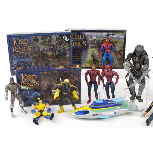 1099 - A group of action figures together with three The Lord of the Rings Strategy Battle games.