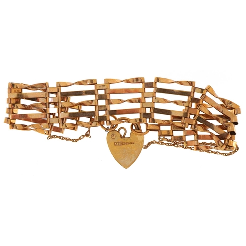 3003 - A 9ct gold five row gate bracelet with love heart padlock clasp, 16cm in length, 9.5g.