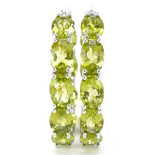 3140 - A pair of silver peridot hoop earrings, total  peridot weight approximately 15 carat, 30mm in diamet... 