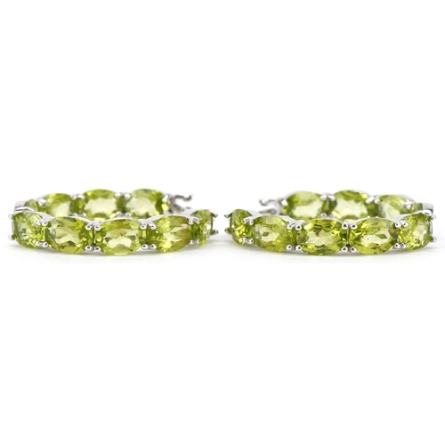 3140 - A pair of silver peridot hoop earrings, total  peridot weight approximately 15 carat, 30mm in diamet... 