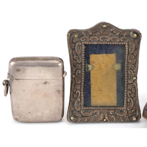 598 - Silver items comprising a Victorian silver vesta, a miniature embossed silver easel photo frame and ... 