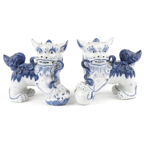 1605 - A pair of Chinese blue and white porcelain Foo dogs, late 20th century, 21cm high x 27cm wide.