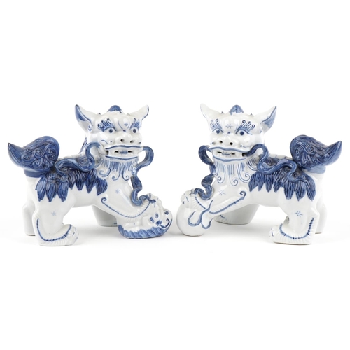 1605 - A pair of Chinese blue and white porcelain Foo dogs, late 20th century, 21cm high x 27cm wide.