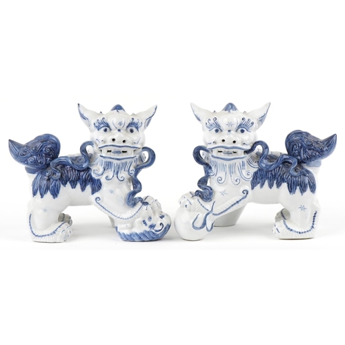 1605 - A pair of Chinese blue and white porcelain Foo dogs, late 20th century, 21cm high x 27cm wide.