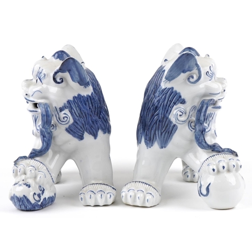 1605 - A pair of Chinese blue and white porcelain Foo dogs, late 20th century, 21cm high x 27cm wide.